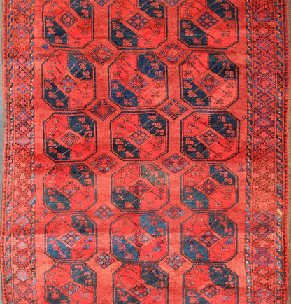 Ersari rug Medium sized hand - knotted rug with a red background with navy blue accents, cased within an intricate border and Gul design within the field. Circa 1940, Turkomen sub geometric, Keivan Woven Arts, rug R20 - 0604 Measurement 7'3... - Keivan Woven ArtsR20 - 0604 - 12946Rug