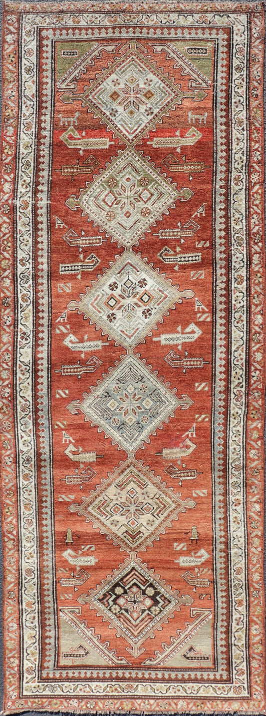 Antique Kurdish Runner with Rusty Red Background and Medallions Tribal Motifs All - over Medallion antique Persian Kurdish runner in soft red - rust, rug R20 - 0705, country of origin / type: Iran / Kurdish, circa 1910 This Kurdish tribal rug w... - Keivan Woven ArtsR20 - 0705 - 12968