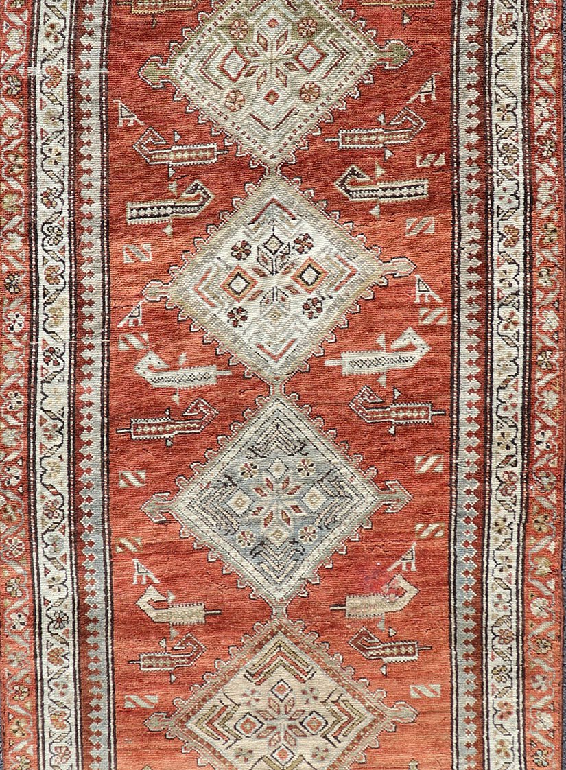 Antique Kurdish Runner with Rusty Red Background and Medallions Tribal Motifs All - over Medallion antique Persian Kurdish runner in soft red - rust, rug R20 - 0705, country of origin / type: Iran / Kurdish, circa 1910 This Kurdish tribal rug w... - Keivan Woven ArtsR20 - 0705 - 12968Rug
