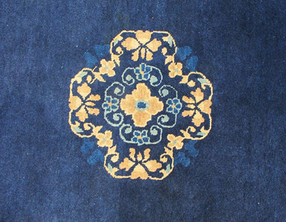 Antique Chinese Peking Carpet The saturated blue field of this piece forms a vibrant backdrop for a medallion with four - corner lotus blossom flowers, which were symbols of purity and spirituality in Buddhist traditions. An unusual interlocking f... - Keivan Woven ArtsS12 - 0510 - 3245Rug