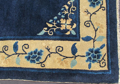 Antique Chinese Peking Carpet The saturated blue field of this piece forms a vibrant backdrop for a medallion with four - corner lotus blossom flowers, which were symbols of purity and spirituality in Buddhist traditions. An unusual interlocking f... - Keivan Woven ArtsS12 - 0510 - 3245Rug