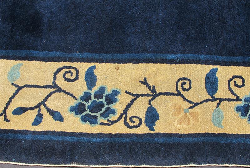 Antique Chinese Peking Carpet The saturated blue field of this piece forms a vibrant backdrop for a medallion with four - corner lotus blossom flowers, which were symbols of purity and spirituality in Buddhist traditions. An unusual interlocking f... - Keivan Woven ArtsS12 - 0510 - 3245Rug