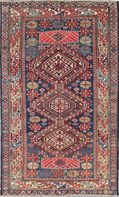 Antique Kazak Rug with In Multi Colors and Indigo Background. This antique, late 19th century Kazak rug from Russia displays three bold, geometric central medallions set on an indigo background and surrounded by multiple complementary geometric... - Keivan Woven ArtsS12 - 0517 - 3720Rug
