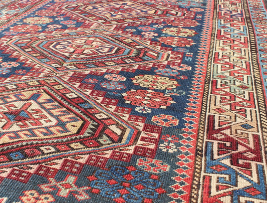 Antique Kazak Rug with In Multi Colors and Indigo Background. This antique, late 19th century Kazak rug from Russia displays three bold, geometric central medallions set on an indigo background and surrounded by multiple complementary geometric... - Keivan Woven ArtsS12 - 0517 - 3720Rug