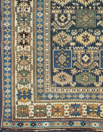 Antique Hand Knotted Caucasian Shirvan Rug in Blue with Tribal Design Measures: 3'3'' x 4'5''. The field of this Caucasian piece features all - over tribal motifs and shapes decorated with small flowers and square designs, alternating c... - Keivan Woven ArtsS12 - 0912 - 3670Rug