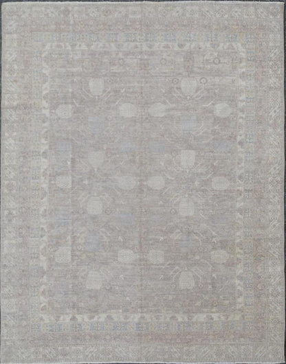 This Khotan features an all - over design flanked by a repeating pattern in the border. The entirety of the piece is rendered in light tones, which makes it a versatile rug, well - suited for a variety of interiors. Colors include light blue, cream and sof... - Keivan Woven ArtsSK - 1319 - 5201Rug