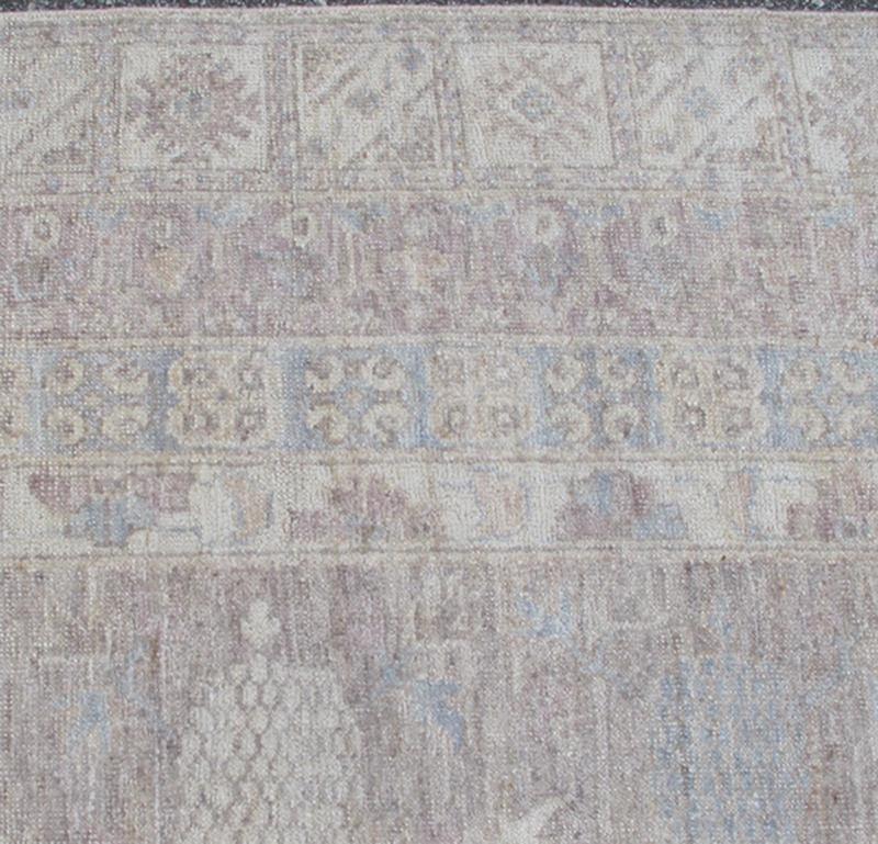 This Khotan features an all - over design flanked by a repeating pattern in the border. The entirety of the piece is rendered in light tones, which makes it a versatile rug, well - suited for a variety of interiors. Colors include light blue, cream and sof... - Keivan Woven ArtsSK - 1319 - 5201Rug