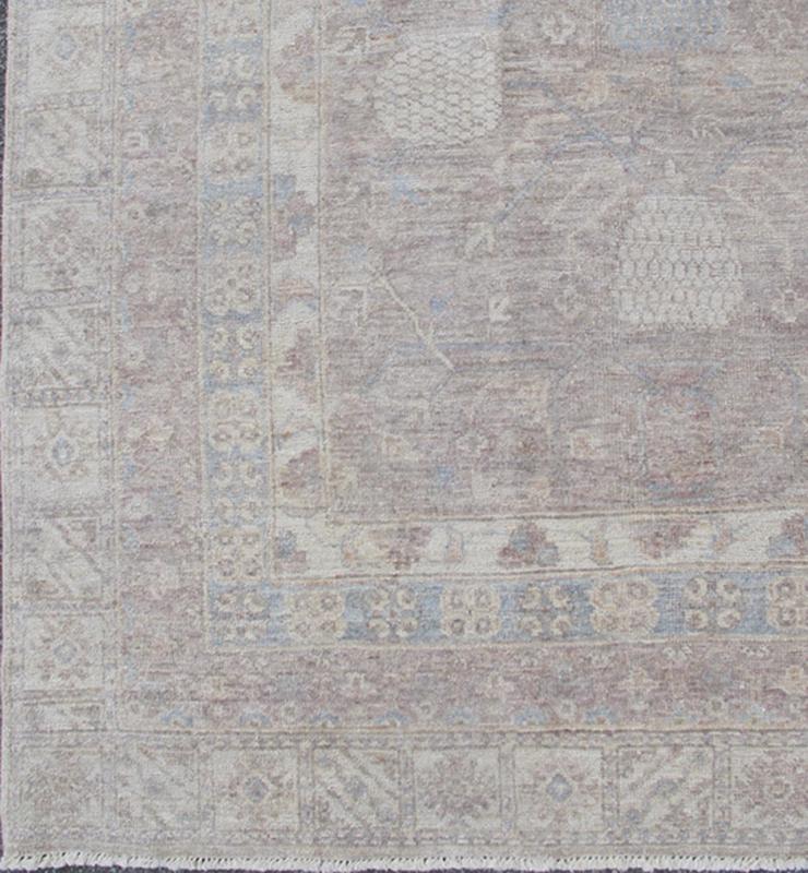This Khotan features an all - over design flanked by a repeating pattern in the border. The entirety of the piece is rendered in light tones, which makes it a versatile rug, well - suited for a variety of interiors. Colors include light blue, cream and sof... - Keivan Woven ArtsSK - 1319 - 5201Rug
