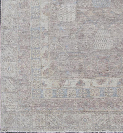 This Khotan features an all - over design flanked by a repeating pattern in the border. The entirety of the piece is rendered in light tones, which makes it a versatile rug, well - suited for a variety of interiors. Colors include light blue, cream and sof... - Keivan Woven ArtsSK - 1319 - 5201Rug