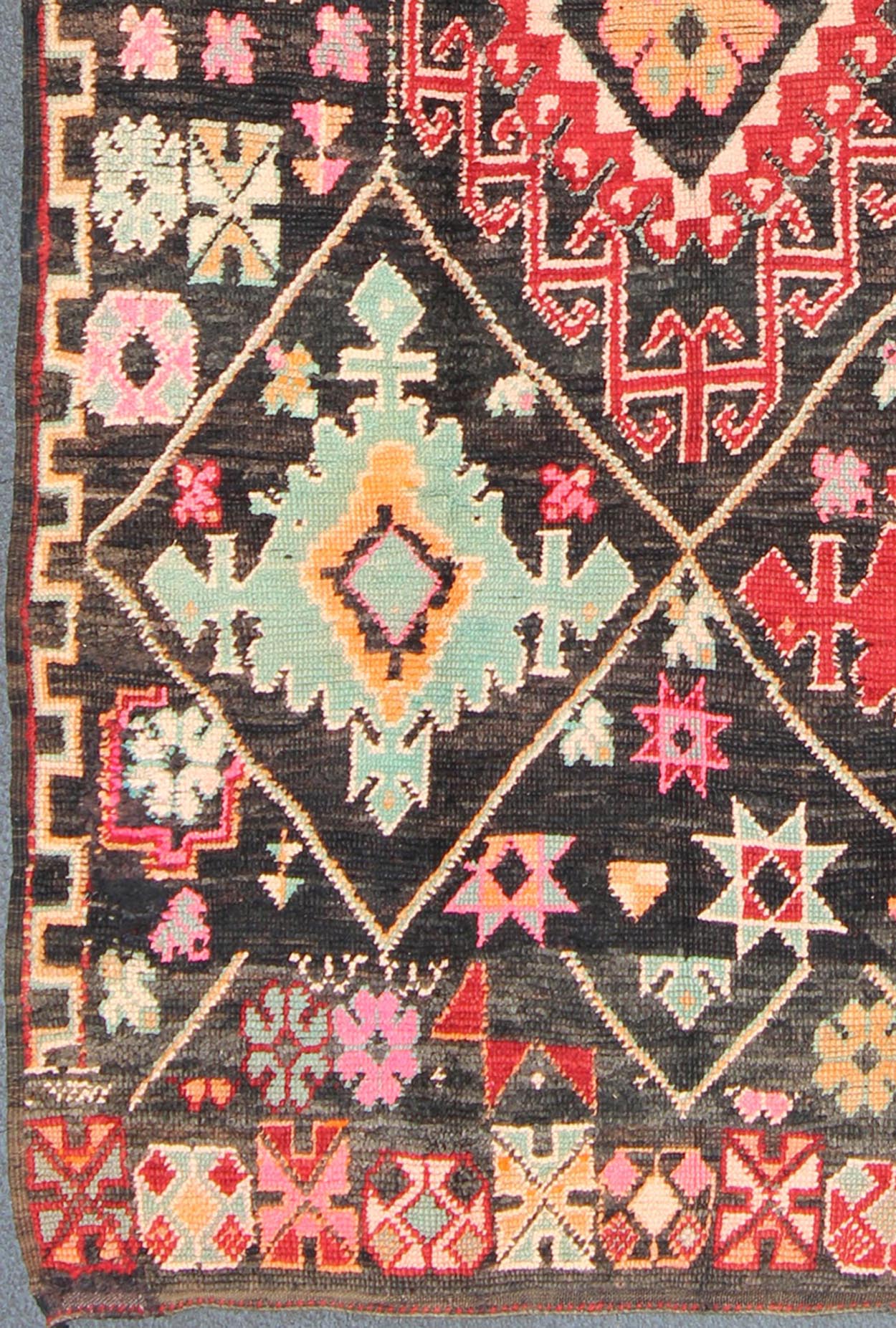 Geometric Tribal Vintage Moroccan Rug in Black, Red, Green and Pink. Keivan Woven Arts / Mid 20th Century / Morocco / Rug SK - 373 With bold diamond and star medallions set on black background, this unique Moroccan displays an array of unexpected col... - Keivan Woven ArtsSK - 373 - 3994Rug
