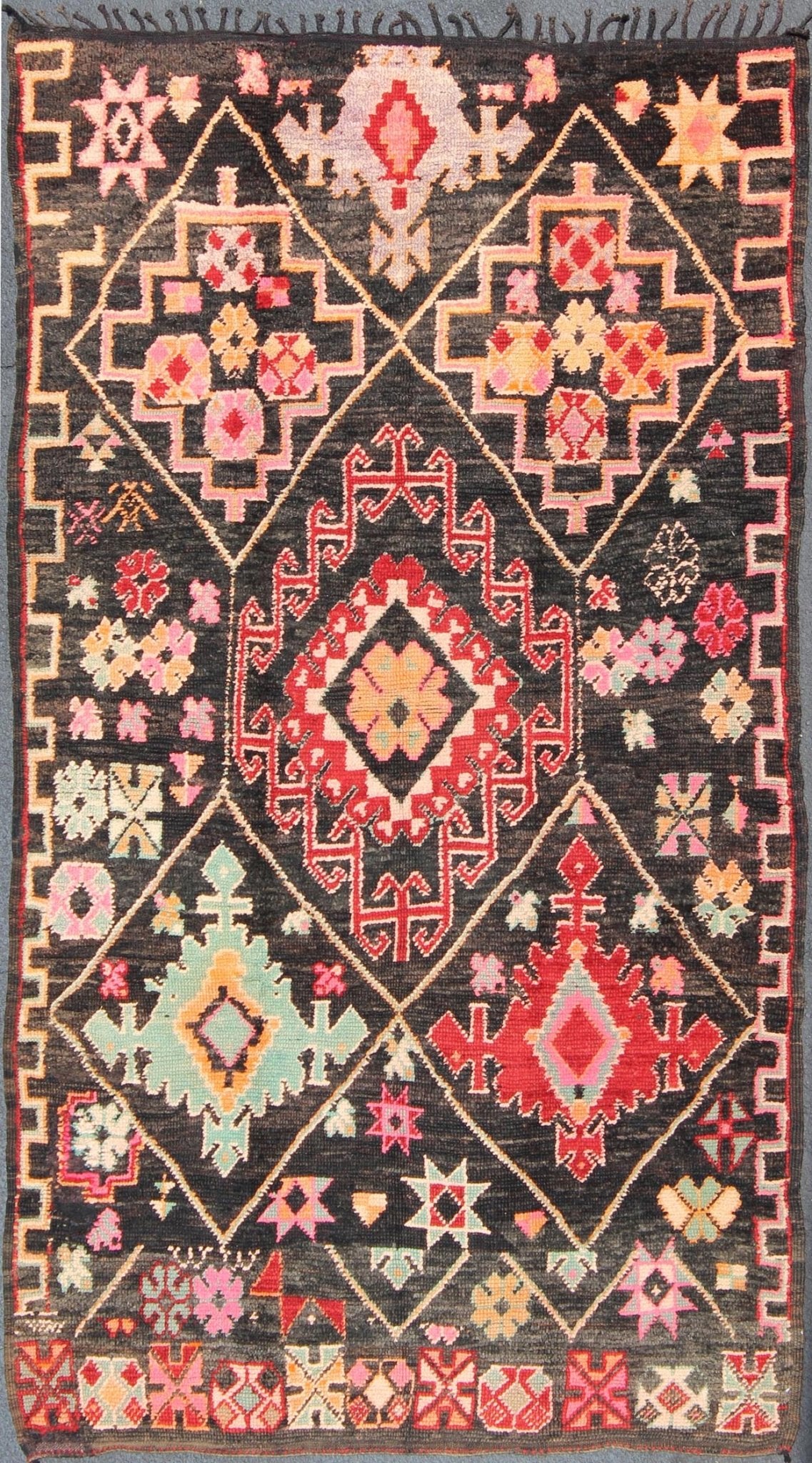Geometric Tribal Vintage Moroccan Rug in Black, Red, Green and Pink. Keivan Woven Arts / Mid 20th Century / Morocco / Rug SK - 373 With bold diamond and star medallions set on black background, this unique Moroccan displays an array of unexpected col... - Keivan Woven ArtsSK - 373 - 3994Rug