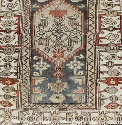 Long Persian Kurdish Runner with Medallion Design in Charcoal, Ivory and Red Antique Persian Kurdish long runner with tribal medallions, rug SUS - 1908 - 115, country of origin / type: Iran or Kurdish, circa 1900. Long Persian Kurdish runner in char... - Keivan Woven ArtsSUS - 1908 - 115 - 11529Rug