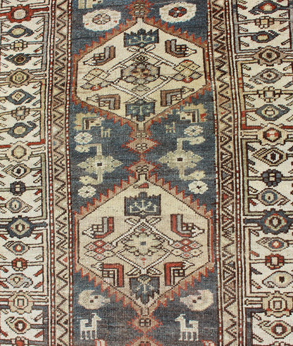 Long Persian Kurdish Runner with Medallion Design in Charcoal, Ivory and Red Antique Persian Kurdish long runner with tribal medallions, rug SUS - 1908 - 115, country of origin / type: Iran or Kurdish, circa 1900. Long Persian Kurdish runner in char... - Keivan Woven ArtsSUS - 1908 - 115 - 11529Rug