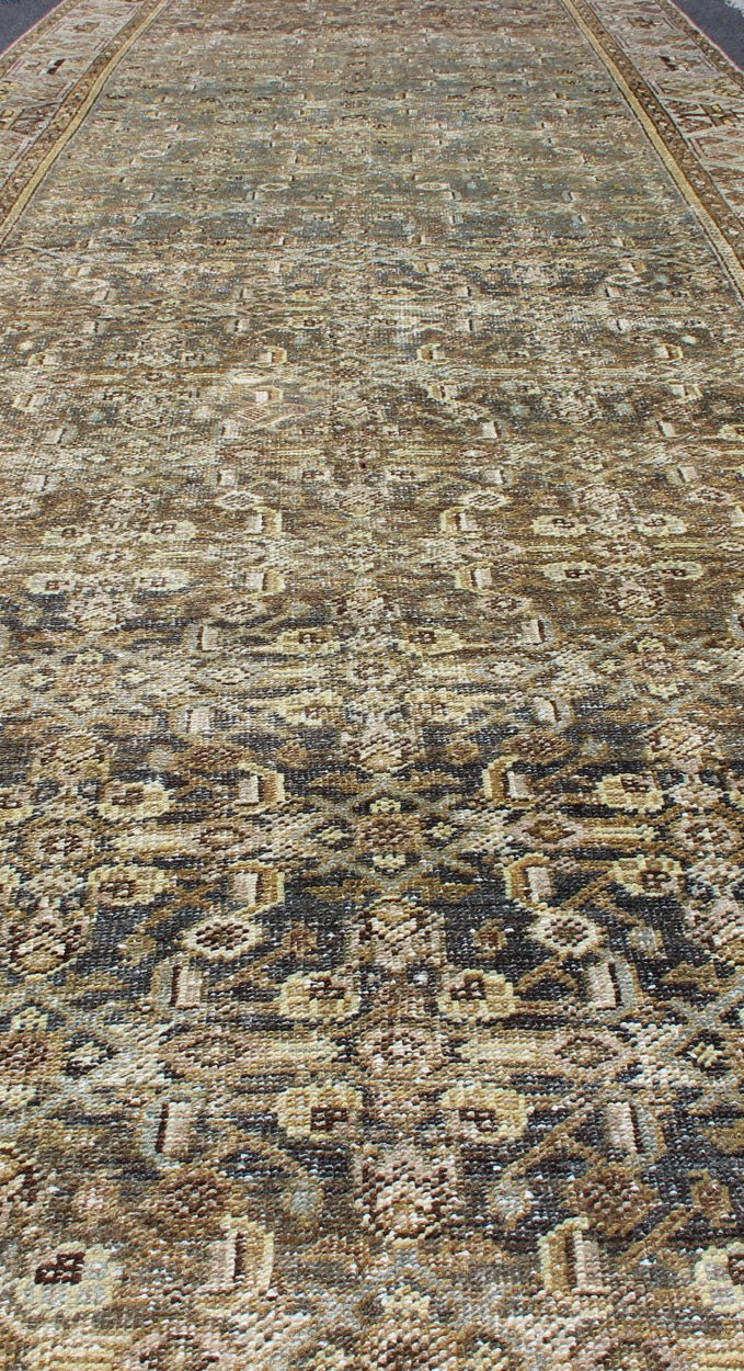 Wide and Long Antique Persian Malayer Runner with All - Over Design in Dark Gray. Rare Persian Malayer Antique wide runner with all - over Herati design in dark gray background and variation of blue, yellow green, light gray, soft yellow, rug SUS - 2007 - ... - Keivan Woven ArtsSUS - 2007 - 38 - 13056Rug