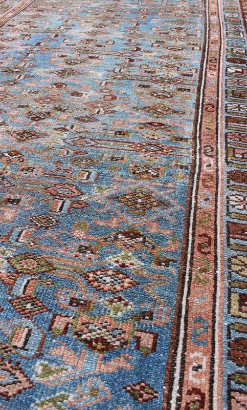Early 20th Century Long Kurdish Runner with Blue, Red, Green and Salmon Pink kwarugs This antique Kurdish tribal runner was woven by Kurdish weavers in western Persia in the early 20th century. Often they used this repeating latch - hook design in... - Keivan Woven ArtsSUS - 229 - 8413Rug