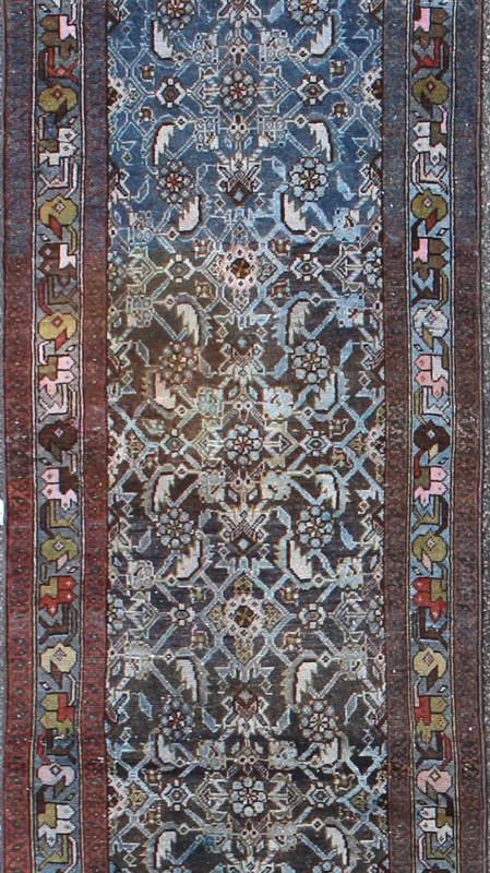 Early 20th Century Very Long Kurdish Runner with Dark/Light Blue, Red and Taupe kwarugs This Kurdish tribal rug was woven by Kurdish weavers in western Persia in the early 20th century. Often they used this repeating latch - hook design in the... - Keivan Woven ArtsSUS - 259 - 8421Rug