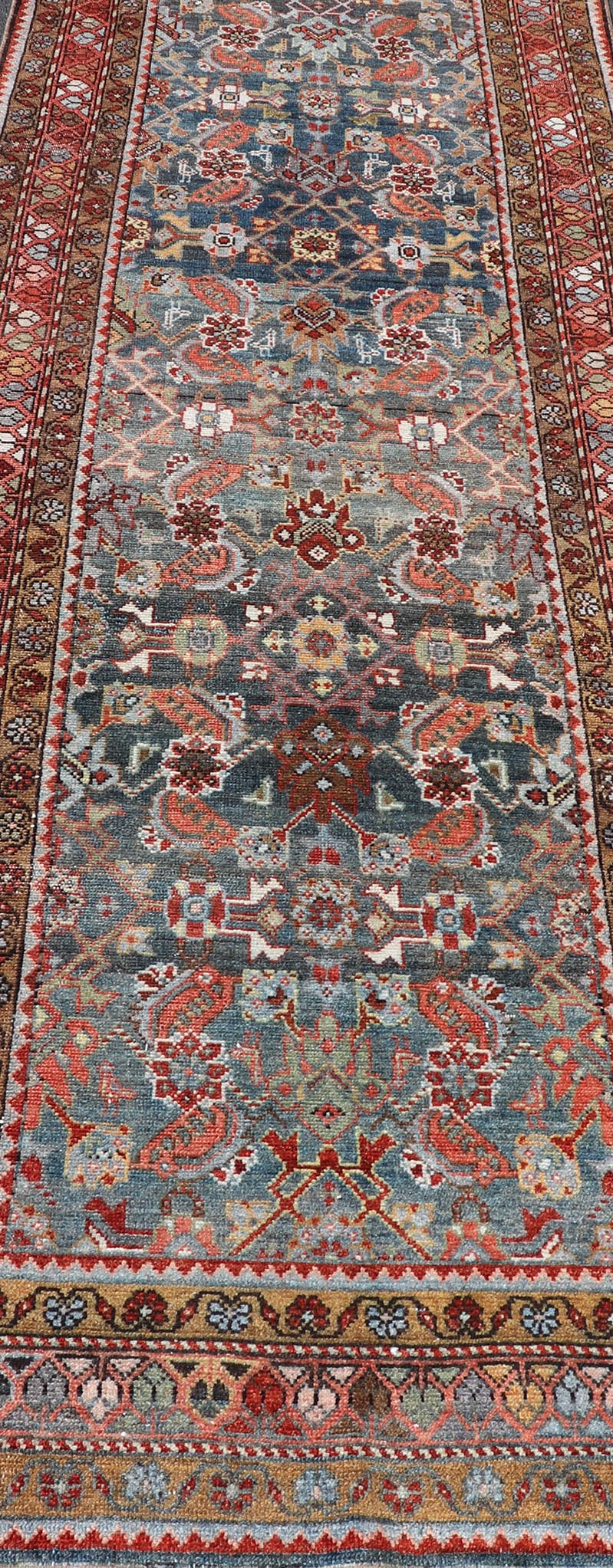 N.W. Persian Runner with Geometric Florals Set on a Deep Blue Field This Northwest Persian runner features a deep blue background flanked by multiple sand - colored and red borders. The elegant, all - over design in the field consists of a free - flow... - Keivan Woven ArtsSUS - 60 - 8395Rug
