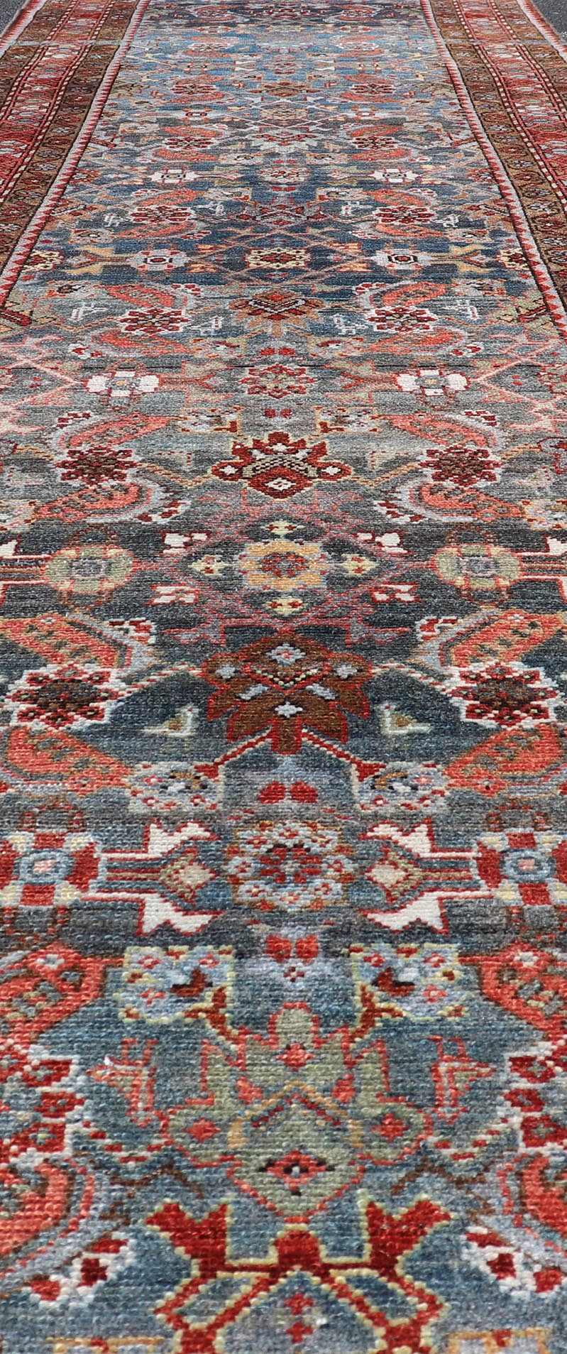 N.W. Persian Runner with Geometric Florals Set on a Deep Blue Field This Northwest Persian runner features a deep blue background flanked by multiple sand - colored and red borders. The elegant, all - over design in the field consists of a free - flow... - Keivan Woven ArtsSUS - 60 - 8395Rug
