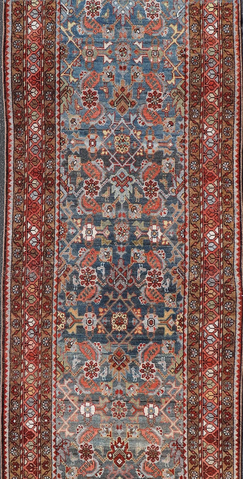 N.W. Persian Runner with Geometric Florals Set on a Deep Blue Field This Northwest Persian runner features a deep blue background flanked by multiple sand - colored and red borders. The elegant, all - over design in the field consists of a free - flow... - Keivan Woven ArtsSUS - 60 - 8395Rug