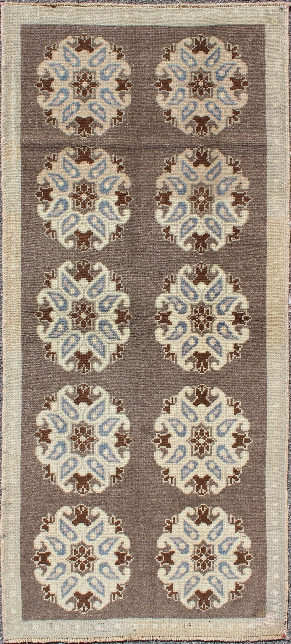 Tribal Turkish Oushak Carpet with Floral Medallions in Taupe, Ivory and Blue Measures: 2'9'' x 6'4''. This Turkish Oushak gallery rug features ten floral medallions that take center stage on a brown field. The border reveals tribal inspiratio... - Keivan Woven ArtsTU - ALK - 3562 - 6787Rug