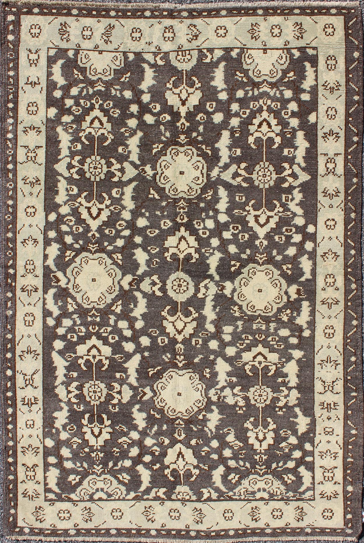 Vintage Turkish Oushak Area Rug in Dark Charcoal, Brown, and Ivory Measures: 3'9 x 5'10 This vintage Oushak was hand - knotted in Turkey during the 1940's. The dark brown field displays clover motifs and other nature designs in antique white ... - Keivan Woven ArtsTU - ALK - 3567 - 6805Rug