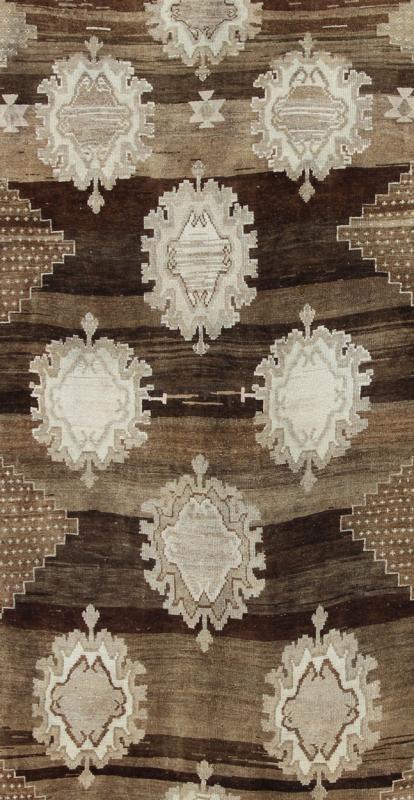 Large Gallery Oushak Rug with Geometric Design and Florals This gallery rug displays 12 medallions that take center stage on a mocha and chocolate brown field. The border reveals tribal inspiration in soft shades of taupe, ivory and chocolate br... - Keivan Woven ArtsTU - ALK - 3579 - 6810Rug