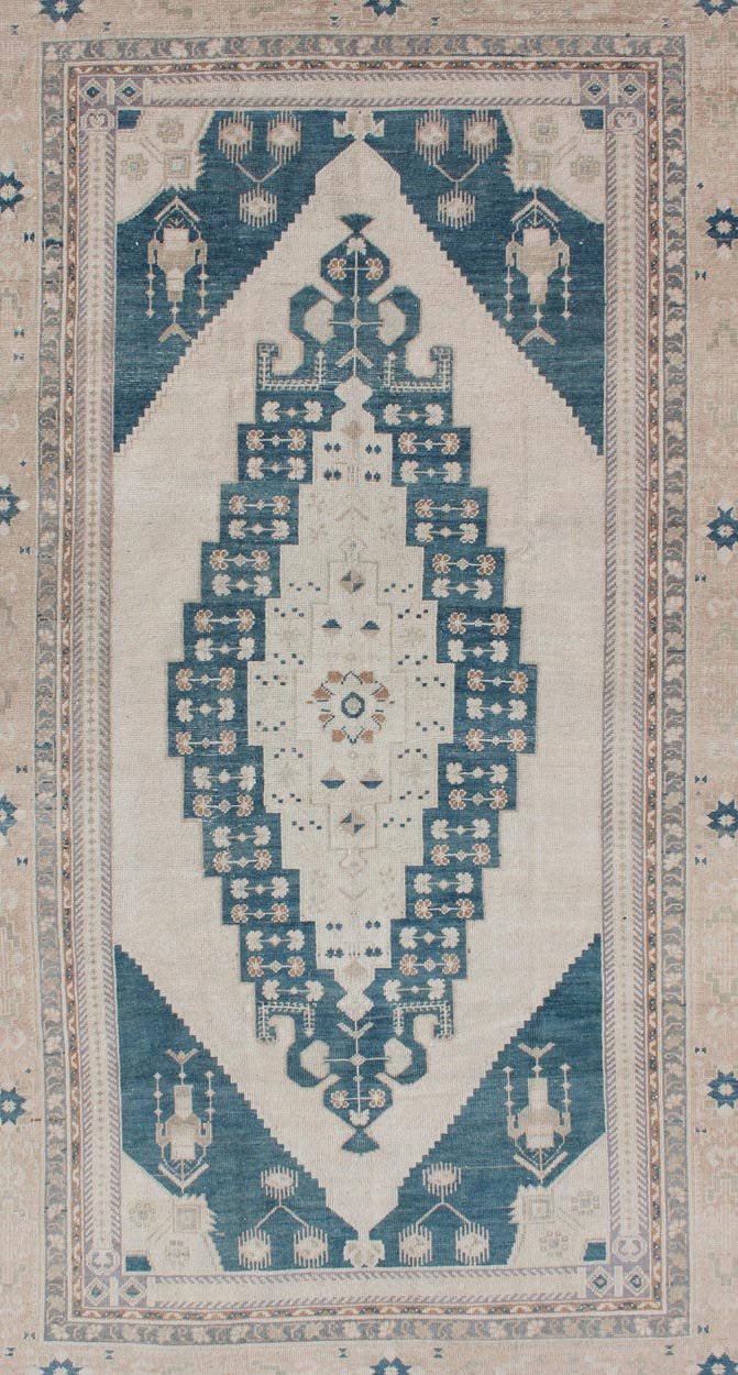 Blue Taupe and Cream Turkish Oushak with Stretched Medallion Medallion Design Oushak Rug from Turkey in Cream and Blue Tones, rug TU - ALK - 4895, country of origin / type: Turkey / Oushak, circa 1940 This vintage Turkish Oushak rug features ... - Keivan Woven ArtsTU - ALK - 4895 - 10740Rug