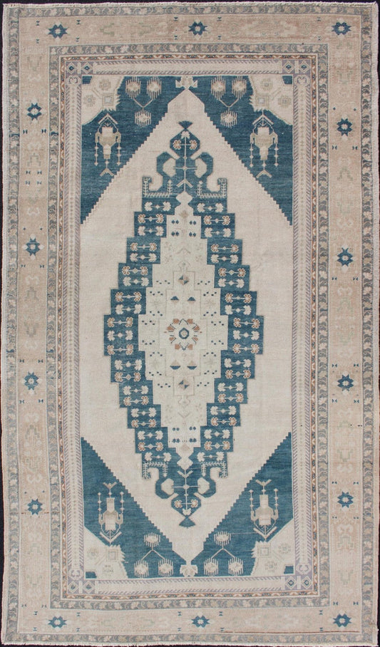 Blue Taupe and Cream Turkish Oushak with Stretched Medallion Medallion Design Oushak Rug from Turkey in Cream and Blue Tones, rug TU - ALK - 4895, country of origin / type: Turkey / Oushak, circa 1940 This vintage Turkish Oushak rug features ... - Keivan Woven ArtsTU - ALK - 4895 - 10740Rug