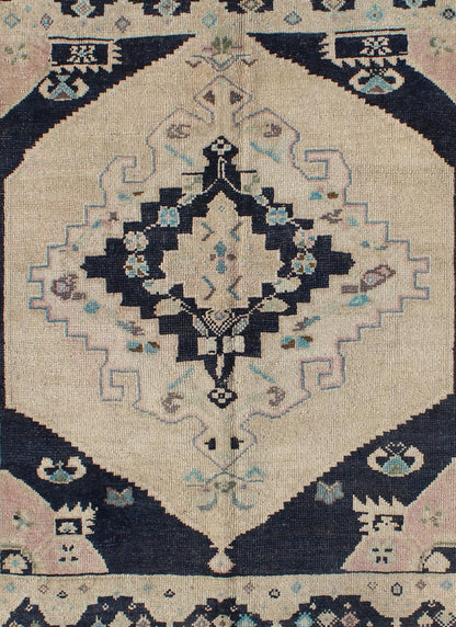 Vintage Hand Knotted Turkish Oushak Rug with Central Medallion in Cream and Blue This beautiful rug from mid - 20th century Turkey features a medallion with floral motifs surrounding it. The cream ground is home to the center medallion. Four dark ... - Keivan Woven ArtsTU - DUR - 3693 - 7903Rug