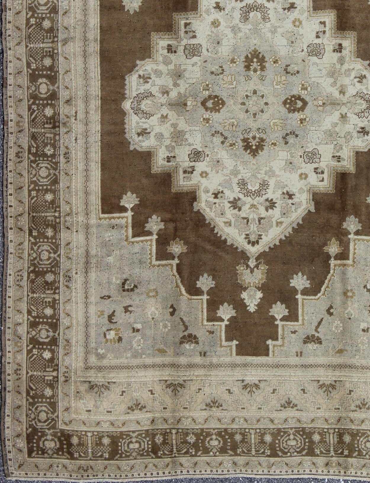 Vintage Turkish Oushak Rug in Brown Background and Neutral Colors Measures: 7'4 x 11'4 This lovely Turkish Oushak from the 1940's features a central medallion, which rests on a dark brown background, is surrounded by a light brown bor... - Keivan Woven ArtsTU - DUR - 506 - 3502Rug
