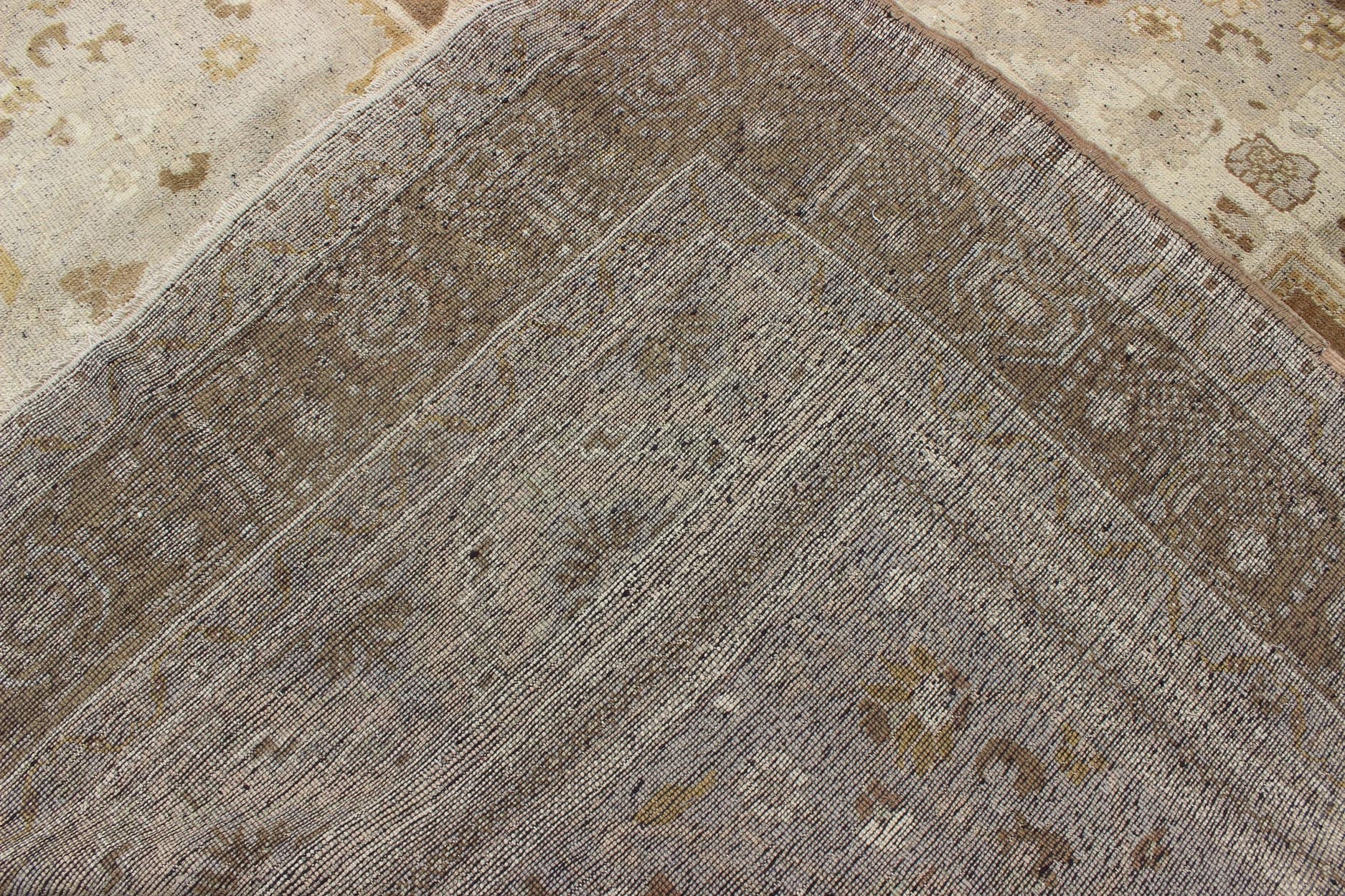 Vintage Turkish Oushak Rug in Brown Background and Neutral Colors Measures: 7'4 x 11'4 This lovely Turkish Oushak from the 1940's features a central medallion, which rests on a dark brown background, is surrounded by a light brown bor... - Keivan Woven ArtsTU - DUR - 506 - 3502Rug