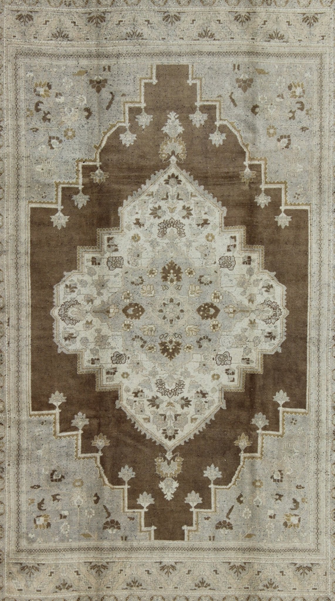 Vintage Turkish Oushak Rug in Brown Background and Neutral Colors Measures: 7'4 x 11'4 This lovely Turkish Oushak from the 1940's features a central medallion, which rests on a dark brown background, is surrounded by a light brown bor... - Keivan Woven ArtsTU - DUR - 506 - 3502Rug