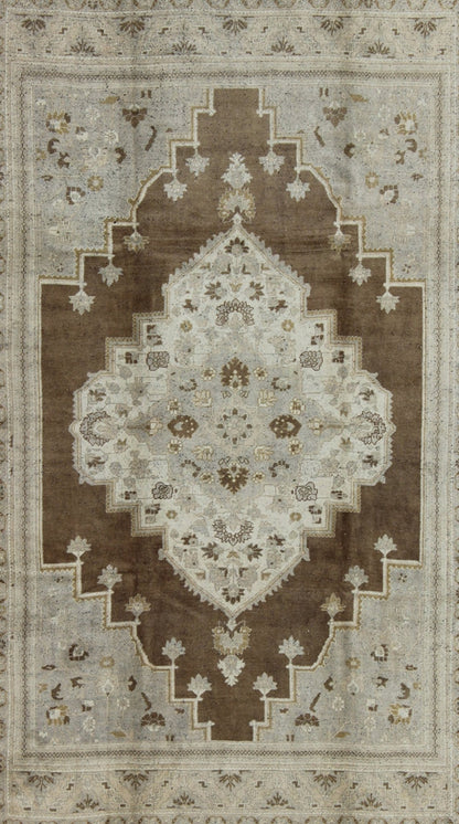 Vintage Turkish Oushak Rug in Brown Background and Neutral Colors Measures: 7'4 x 11'4 This lovely Turkish Oushak from the 1940's features a central medallion, which rests on a dark brown background, is surrounded by a light brown bor... - Keivan Woven ArtsTU - DUR - 506 - 3502Rug