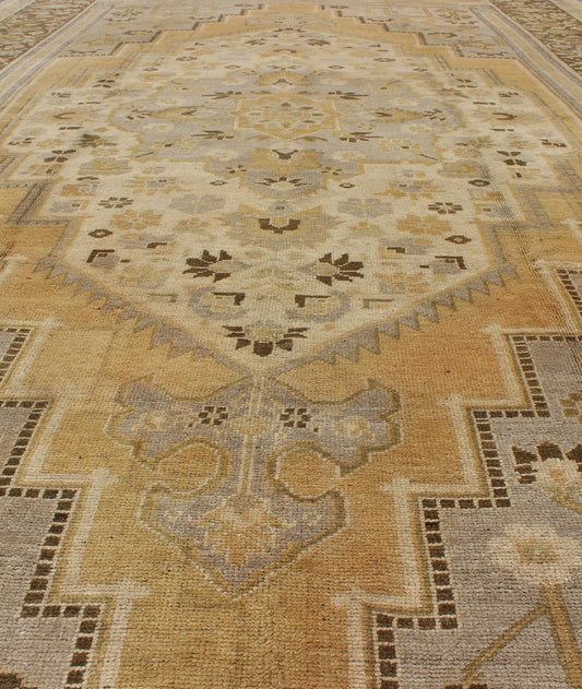 Vintage Turkish Medallion Oushak Rug in Gold, Taupe, Cream and Cocoa Measures: 6'8 x 12 This vintage Turkish Oushak features a bold design softened by unique, light tones. The border is chocolate brown and contains vines and flowers. Co... - Keivan Woven ArtsTU - DUR - 507 - 3508Rug