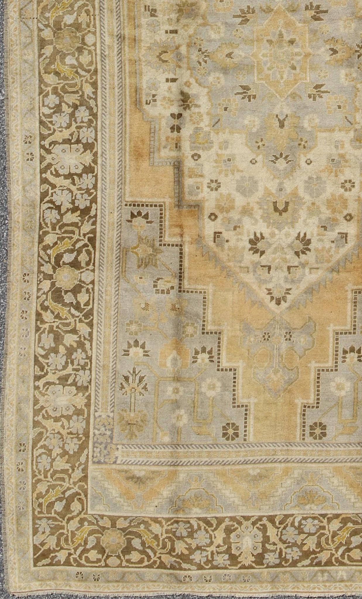Vintage Turkish Medallion Oushak Rug in Gold, Taupe, Cream and Cocoa Measures: 6'8 x 12 This vintage Turkish Oushak features a bold design softened by unique, light tones. The border is chocolate brown and contains vines and flowers. Co... - Keivan Woven ArtsTU - DUR - 507 - 3508Rug