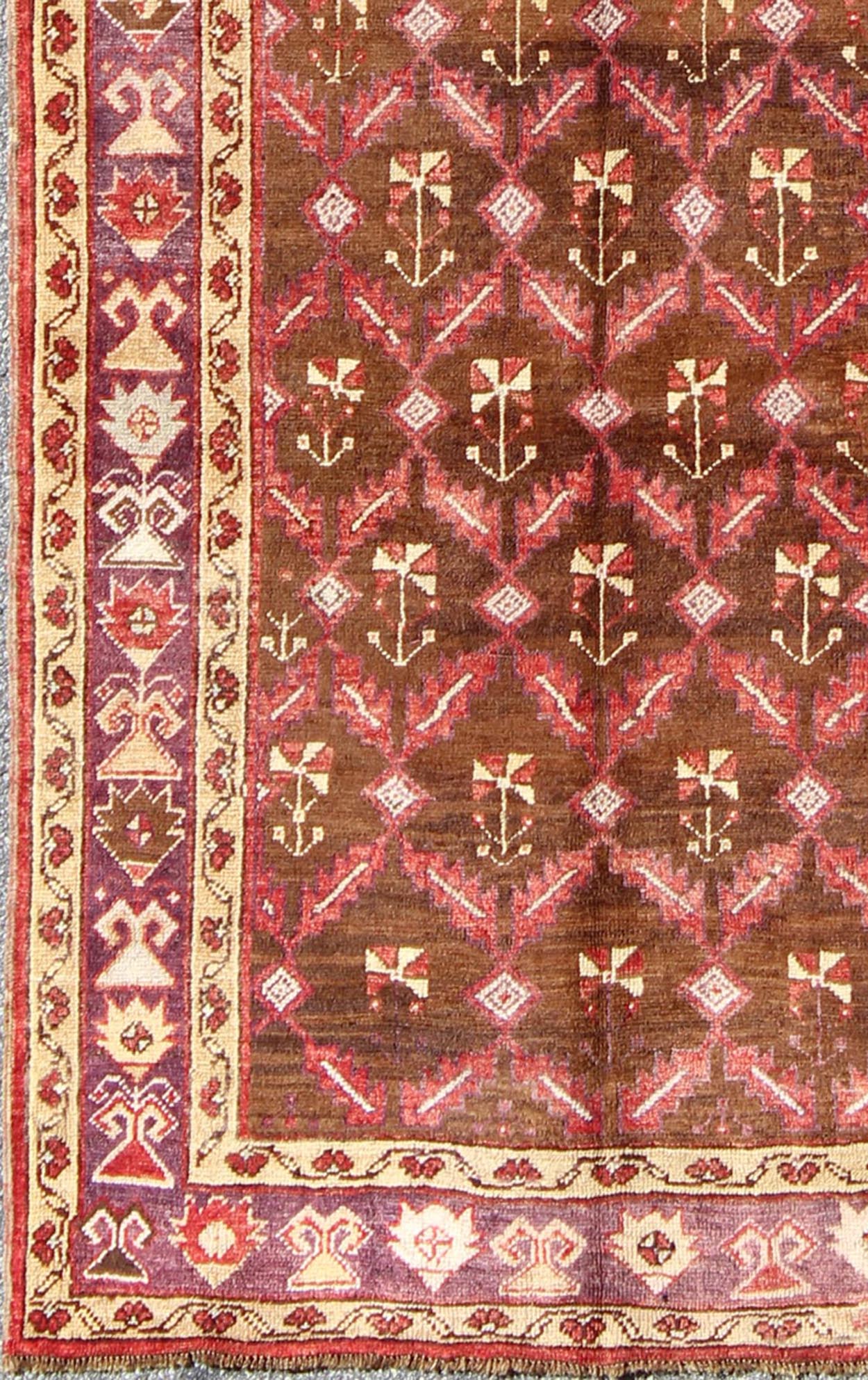 Vintage Turkish Oushak Carpet with All - Over Tribal Design in Red, Purple & Brown: Produced in mid - 20th century Turkey, this vintage Oushak is characterized by a comely and highly representative Oushak composition. Building on traditional designs, this ... - Keivan Woven ArtsTU - EMD - 3368 - 6161Rug
