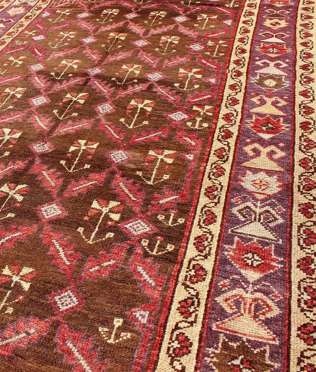 Vintage Turkish Oushak Carpet with All - Over Tribal Design in Red, Purple & Brown: Produced in mid - 20th century Turkey, this vintage Oushak is characterized by a comely and highly representative Oushak composition. Building on traditional designs, this ... - Keivan Woven ArtsTU - EMD - 3368 - 6161Rug