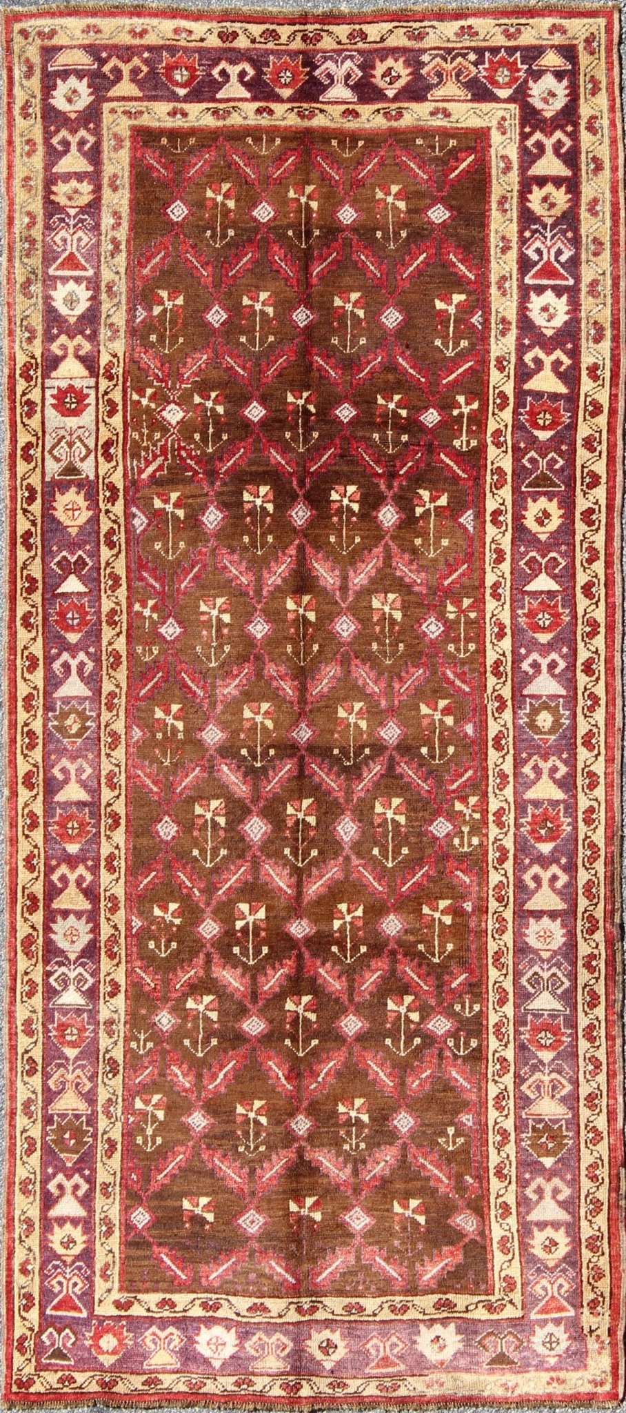Vintage Turkish Oushak Carpet with All - Over Tribal Design in Red, Purple & Brown: Produced in mid - 20th century Turkey, this vintage Oushak is characterized by a comely and highly representative Oushak composition. Building on traditional designs, this ... - Keivan Woven ArtsTU - EMD - 3368 - 6161Rug