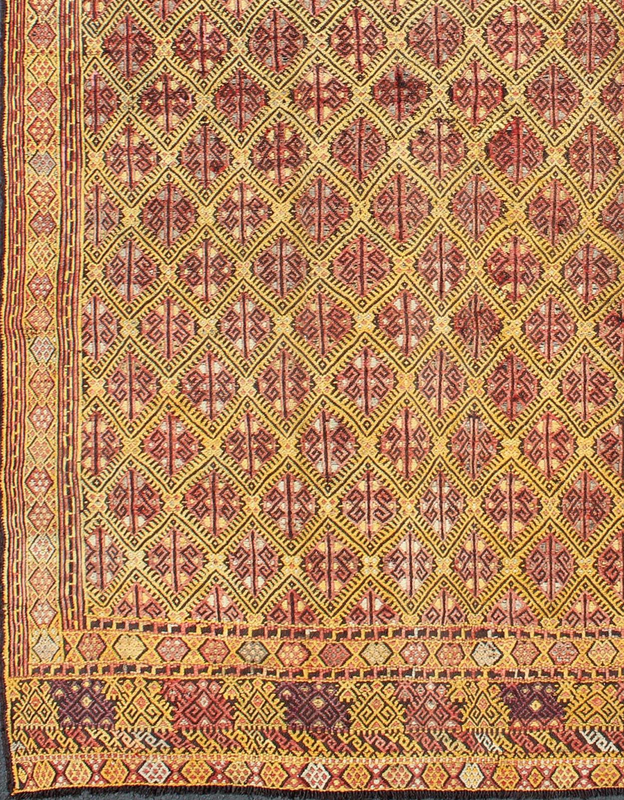 Vintage Turkish Embroidered Kilim Rug With Diamond Design in Yellow and Red This colorful vintage, 20th century embroidered Kilim rug features an all - over diamond pattern woven with a well - preserved and vibrant color palette of Green, soft orange, ... - Keivan Woven ArtsTU - EMD - 3371 - 6165Rug