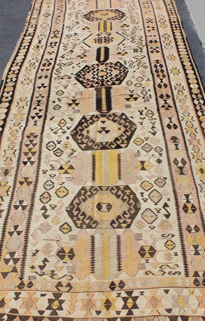 Vintage Turkish kilim gallery rug with tribal medallion design in pink and yellow. Keivan Woven Arts / rug TU - EMD - 3424, country of origin / type: Turkey / Kilim, circa Mid - 20th century. This vintage Turkish Kilim gallery rug (circa mid - 20th cent... - Keivan Woven ArtsTU - EMD - 3424 - 6171Rug