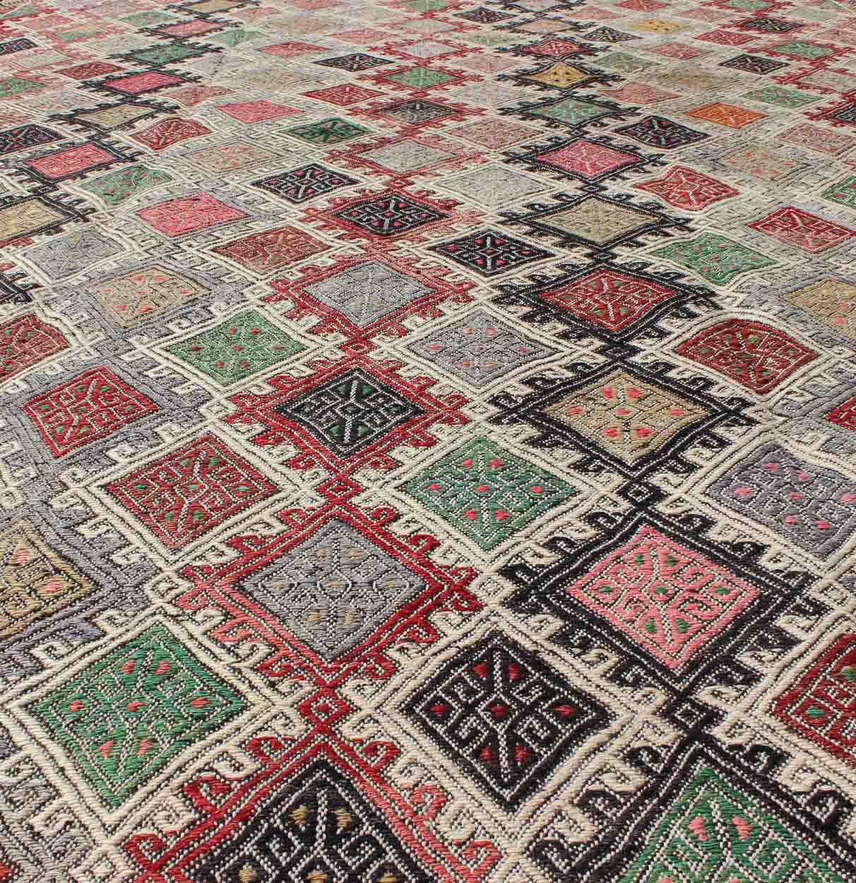 Geometric Embroidered Mid - Century Flat - Weave Kilim Rug From Turkey. This marvelous geometric embroidered Kilim rug showcases an all - over diamond pattern in the background and an understated border, paired with a distinct set of random colors such as pi... - Keivan Woven ArtsTU - EMD - 3427 - 6177Rug