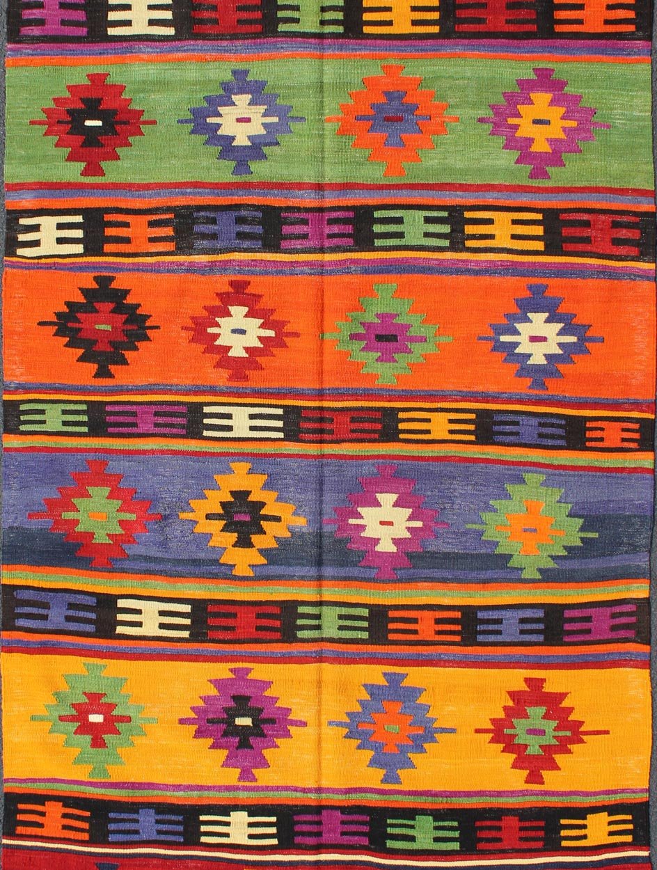 Colorful and Vibrant Turkish Vintage Kilim Rug with Repeating Diamond Pattern: This brilliant and colorful Turkish Kilim rug has a repeating diamond pattern, which is articulated on a background of thick bands of alternating color. This piece is vibran... - Keivan Woven ArtsTU - EMD - 95035 - 3477Rug