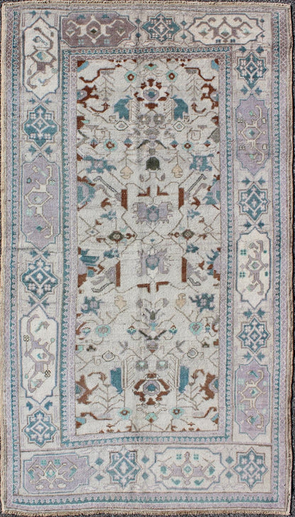 Vintage All - Over Floral Turkish Oushak Area Rug in Cream, Blue, Lilac and Red Measures: 4'4 x 8 This vintage Turkish Oushak carpet (circa mid - 20th century) features an all - over design of sub - geometric floral motifs atop of a creamy backgr... - Keivan Woven ArtsTU - IHS - 123347 - 3638Rug