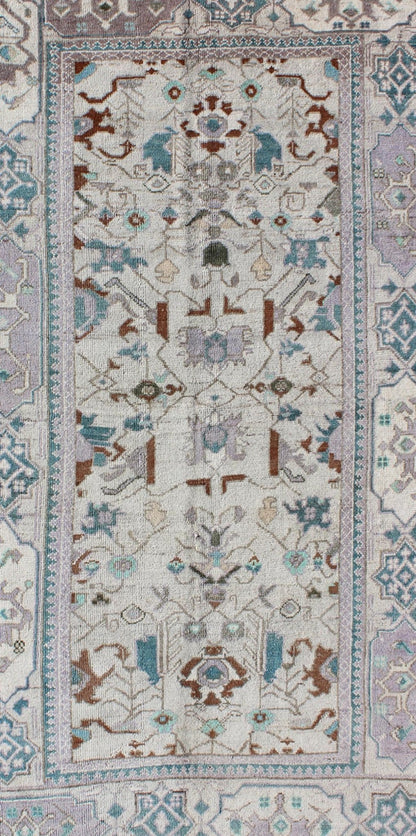 Vintage All - Over Floral Turkish Oushak Area Rug in Cream, Blue, Lilac and Red Measures: 4'4 x 8 This vintage Turkish Oushak carpet (circa mid - 20th century) features an all - over design of sub - geometric floral motifs atop of a creamy backgr... - Keivan Woven ArtsTU - IHS - 123347 - 3638Rug