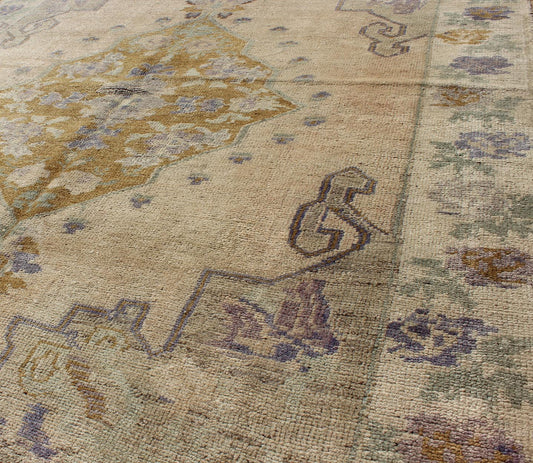 Classic Medallion Oushak Vintage Rug in Taupe, Purple, Cream, and Green This soft and cheerful Oushak carpet proudly displays a unique color combination in any carpet. On the center of this rug lays a central medallion of rich gold color. T... - Keivan Woven ArtsTU - IHS - 123408 - 3644Rug