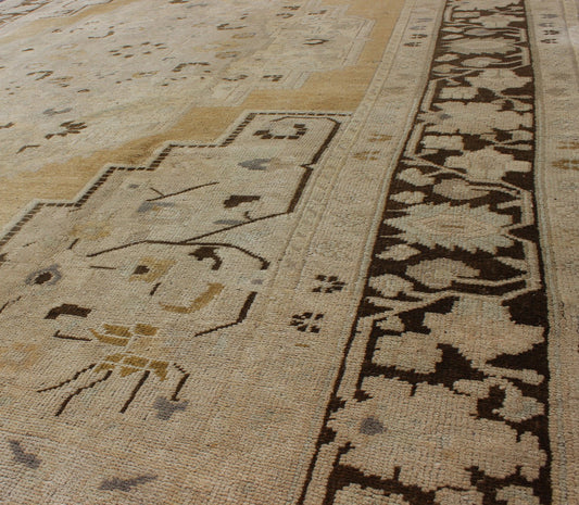 Turkish Oushak Rug in Pale Yellow, Taupe and Brown Border. Keivan Woven Arts, rug/ TU - MTE - 95185. Mid 20 - th century , Turkey. This softly muted Oushak carpet rests beautifully upon a field of elegant golden taupe. A large medallion takes center ... - Keivan Woven ArtsTU - MTE - 95185 - 4976Rug