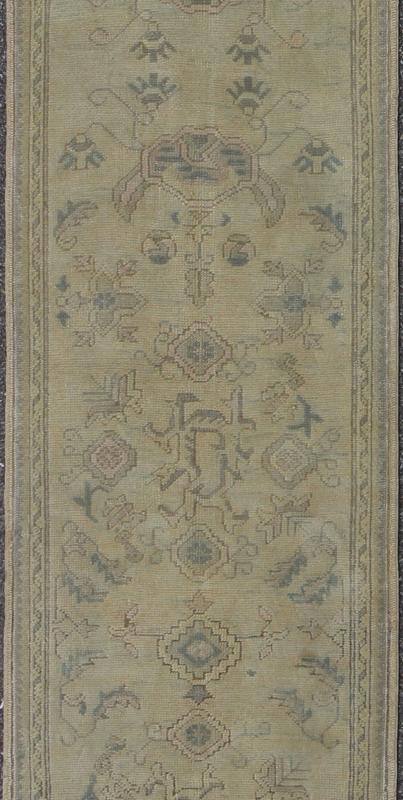 Antique Turkish Oushak Runner with All - Over Design with green and Blue Accents Measures: 2'10 x 12'8. This 1930's antique muted Oushak runner rests beautifully upon a field of elegant cream and taupe. An all - over pattern takes center sta... - Keivan Woven ArtsTU - MTU - 1002 - 8084Rug