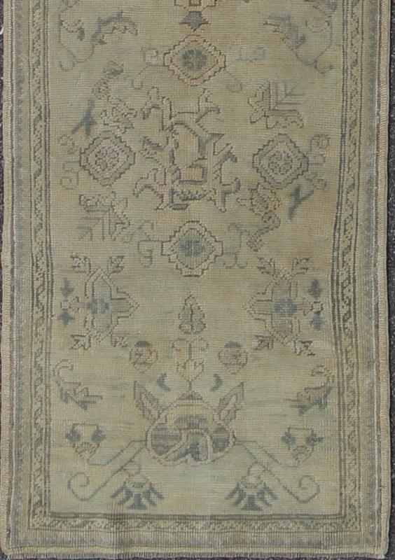 Antique Turkish Oushak Runner with All - Over Design with green and Blue Accents Measures: 2'10 x 12'8. This 1930's antique muted Oushak runner rests beautifully upon a field of elegant cream and taupe. An all - over pattern takes center sta... - Keivan Woven ArtsTU - MTU - 1002 - 8084Rug
