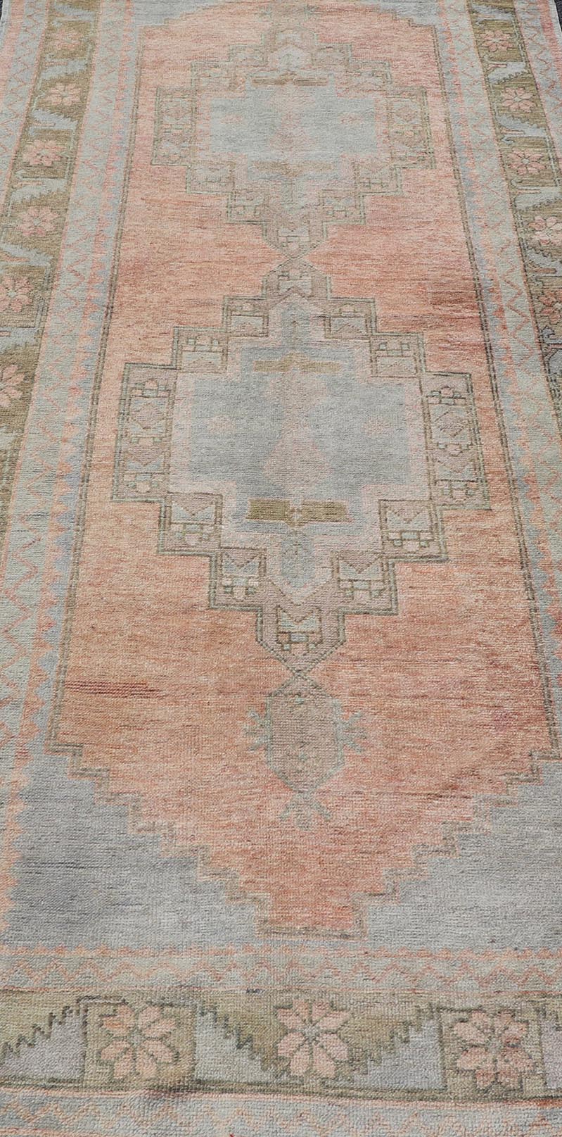 Vintage Turkish Oushak Gallery with Tribal Medallions in Soft Peach and Green Measures: 4'7 x 11'2 This vintage Turkish Oushak features large tribal medallions in light blue and tan. The medallions are decorated in tribal motifs and a p... - Keivan Woven ArtsTU - MTU - 117 - 18740Rug