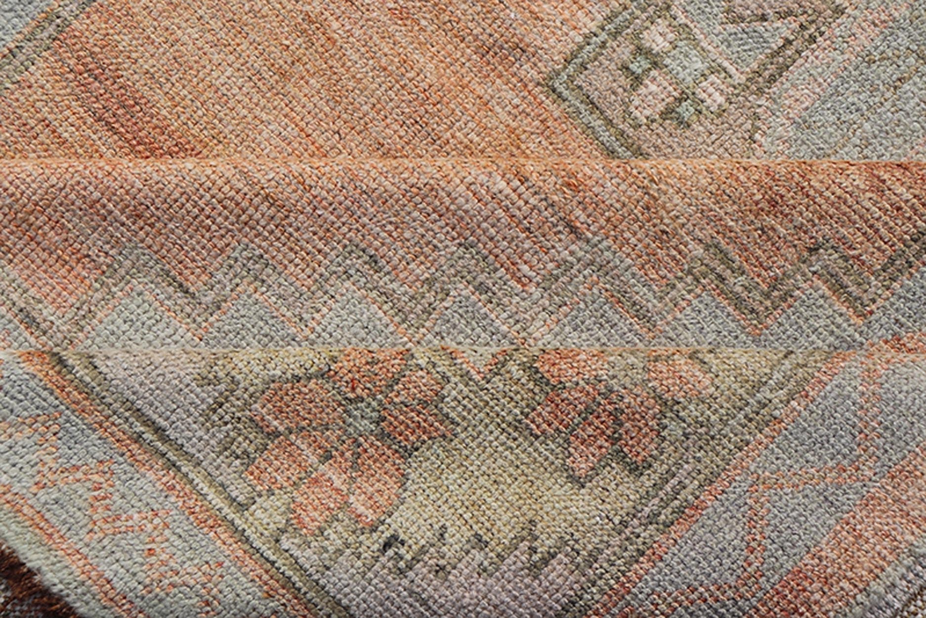 Vintage Turkish Oushak Gallery with Tribal Medallions in Soft Peach and Green Measures: 4'7 x 11'2 This vintage Turkish Oushak features large tribal medallions in light blue and tan. The medallions are decorated in tribal motifs and a p... - Keivan Woven ArtsTU - MTU - 117 - 18740Rug